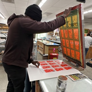 Brown is working on a screen printing project, making cards for gifts.