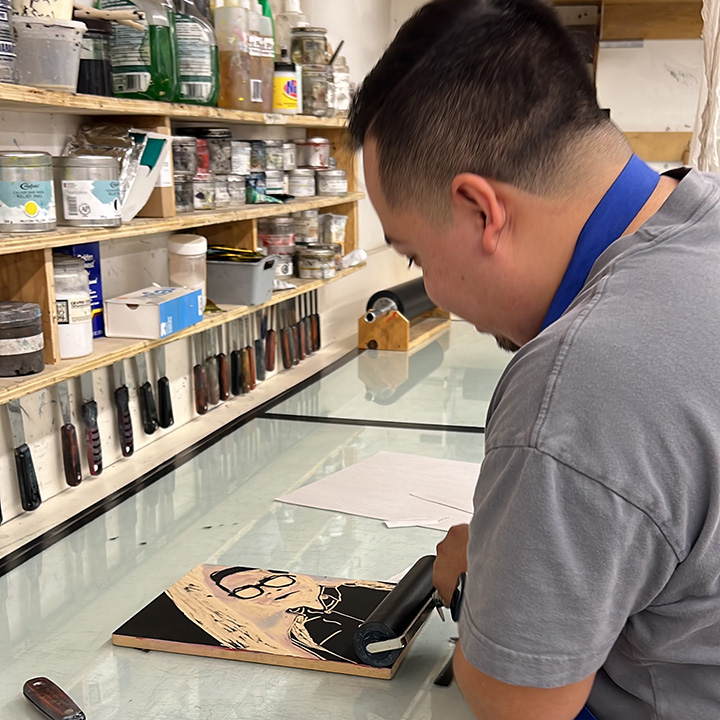 Samuel Diaz, an Art, Design and Art History major, is working on a self-portrait on a woodblock