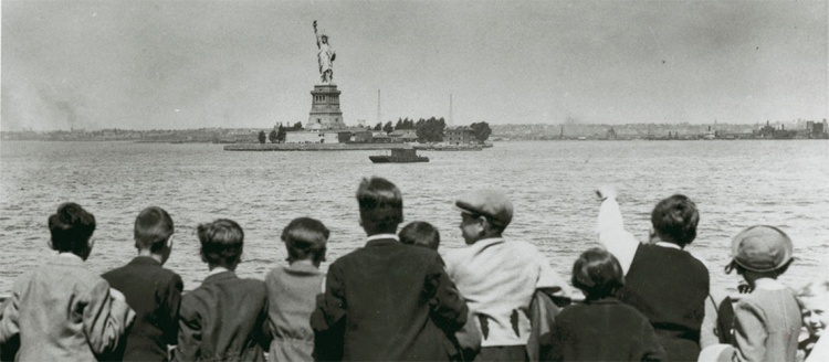 Some of the Jewish children rescued by the Krauses wave to the Statue of Liberty upon arrival in New York, June 1939. US Holocaust Memorial Museum.