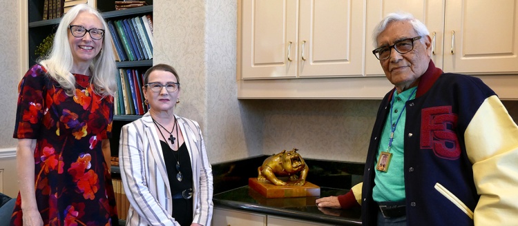 Dean Honora Chapman, Holly Sowles and Joseph Guadalupe Garcia stand next to a small four-paw Bulldog sculpture.