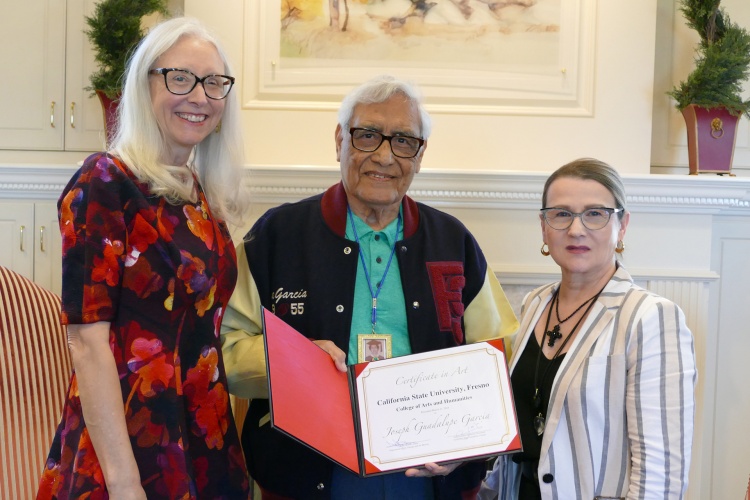 Joseph Garcia holds her Certificate in Art with Dr. Honora Champman, dean of the College of Arts and Humanities (left) and Holly Sowles, Chair of the Department of Art, Design and Art History (right)